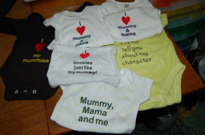 Assorted babygros wtih slogans